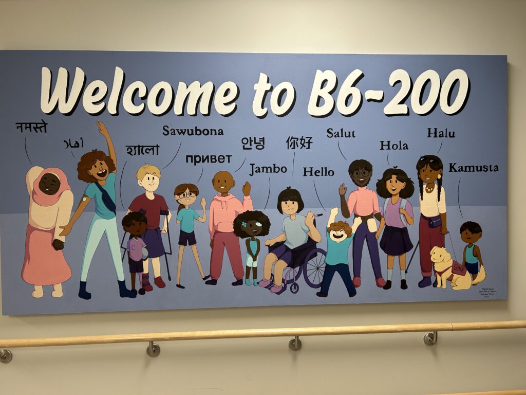 A multicultural-themed mural reading "Welcome to B6-200"