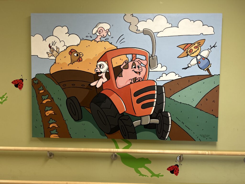 A farm wall mural featuring a pig driving a tractor.