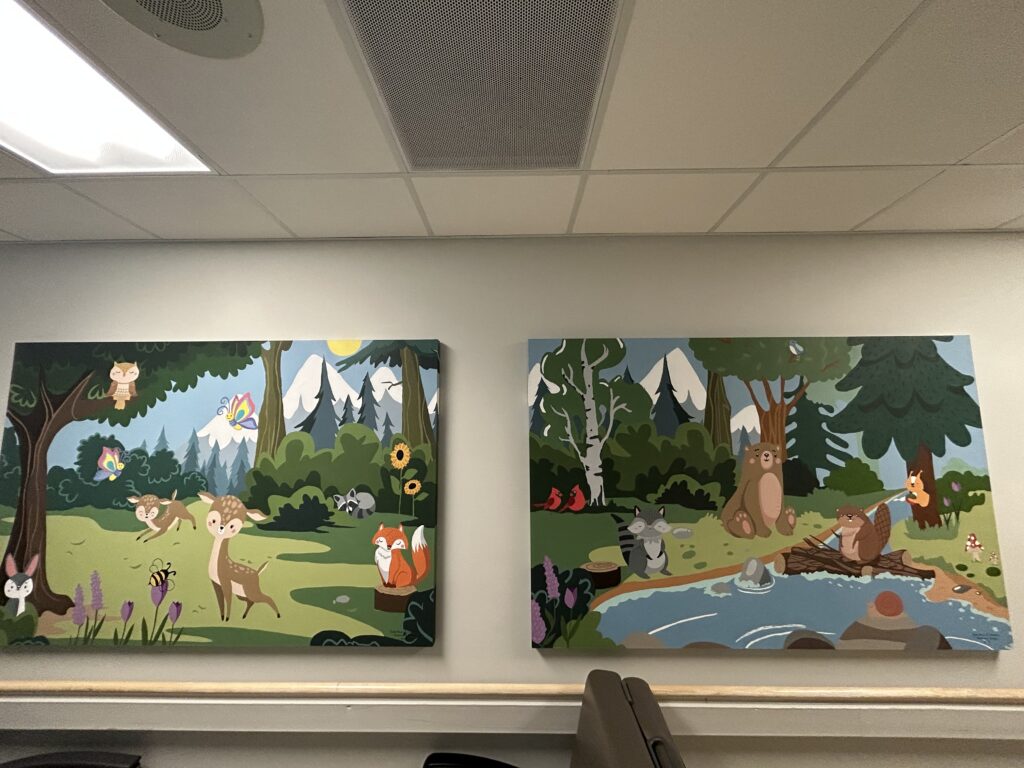 Two wall murals featuring animals in a woodlands scene.